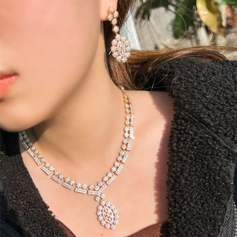 Gold-tone zirconia necklace and teardrop drop earrings set on model