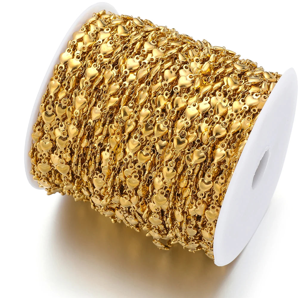 Gold heart chain wound on a spool, featuring repeating small heart links