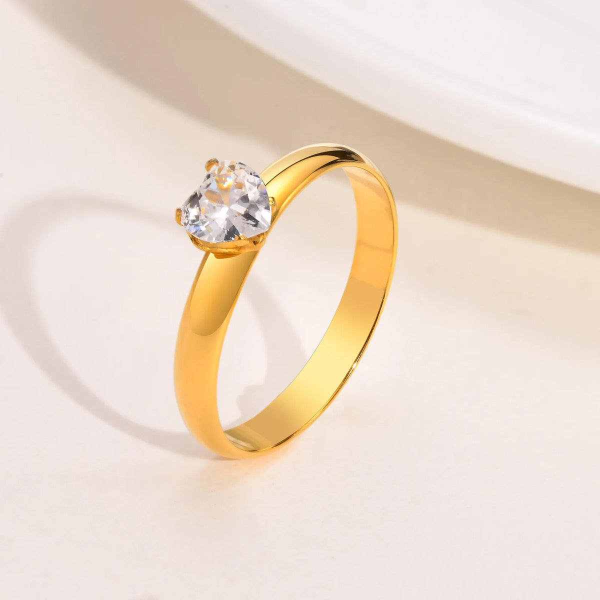 Gold-tone solitaire ring with small round cubic zirconia on open band