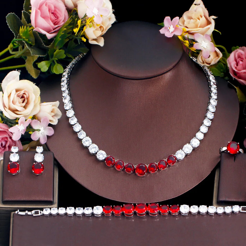 Red cubic zirconia tennis jewelry set with silver necklace, bracelet, ring, and earrings