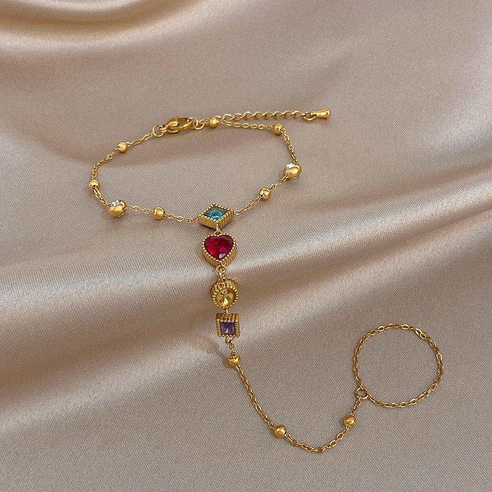 Gold-tone multicolor gemstone bracelet with heart and square dangling charms