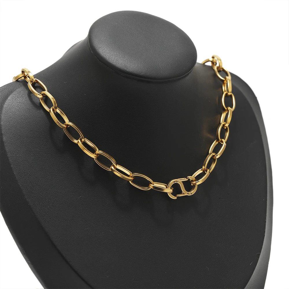 Gold-tone spring lobster clasp connector attached to a necklace chain on a black display