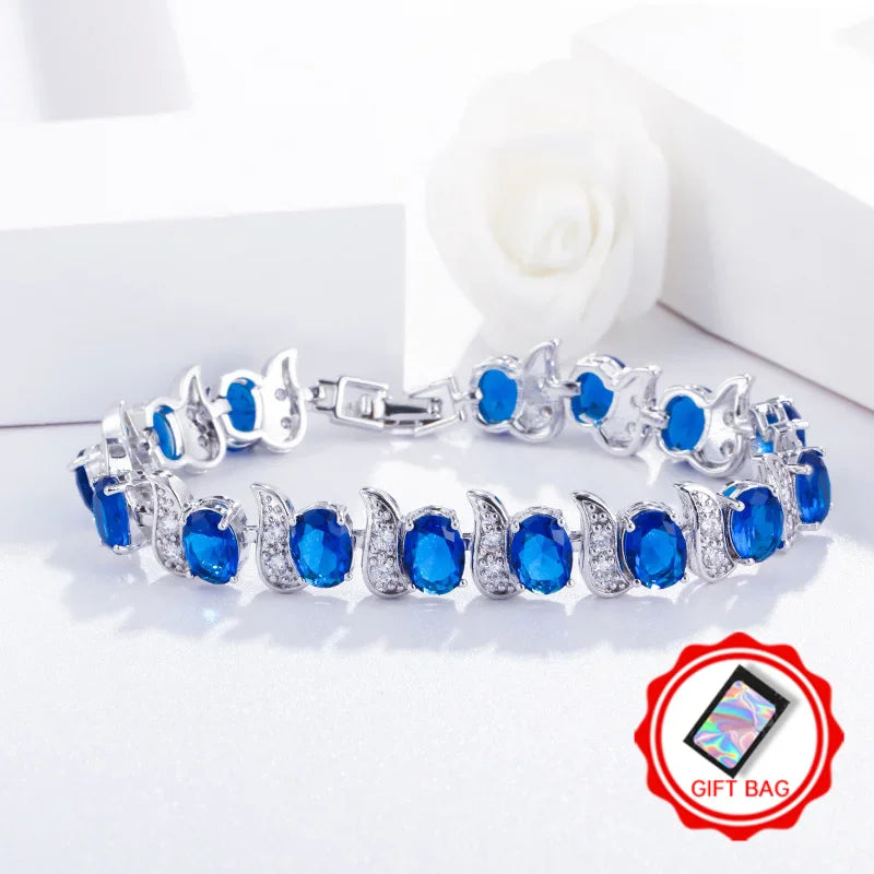 Silver-tone bracelet with blue oval crystals and leaf-shaped crystal links