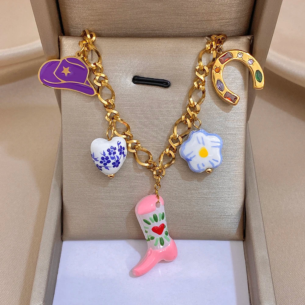 Gold chain necklace with purple crescent charm, horseshoe and boot charms