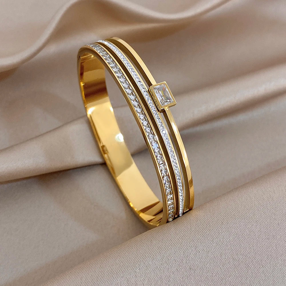 Gold cuff bangle bracelet with clear zircon lines and square accent