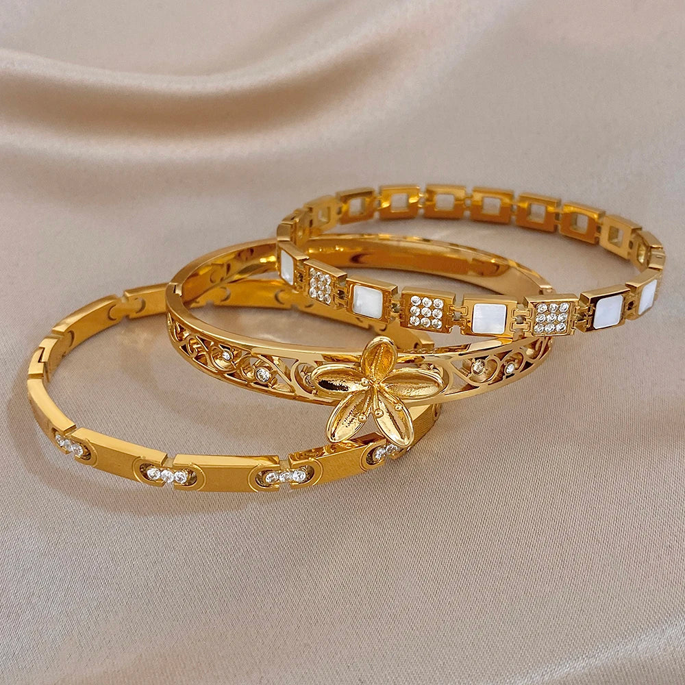 Gold-plated flower cuff bangle with etched filigree and square crystal insets, set