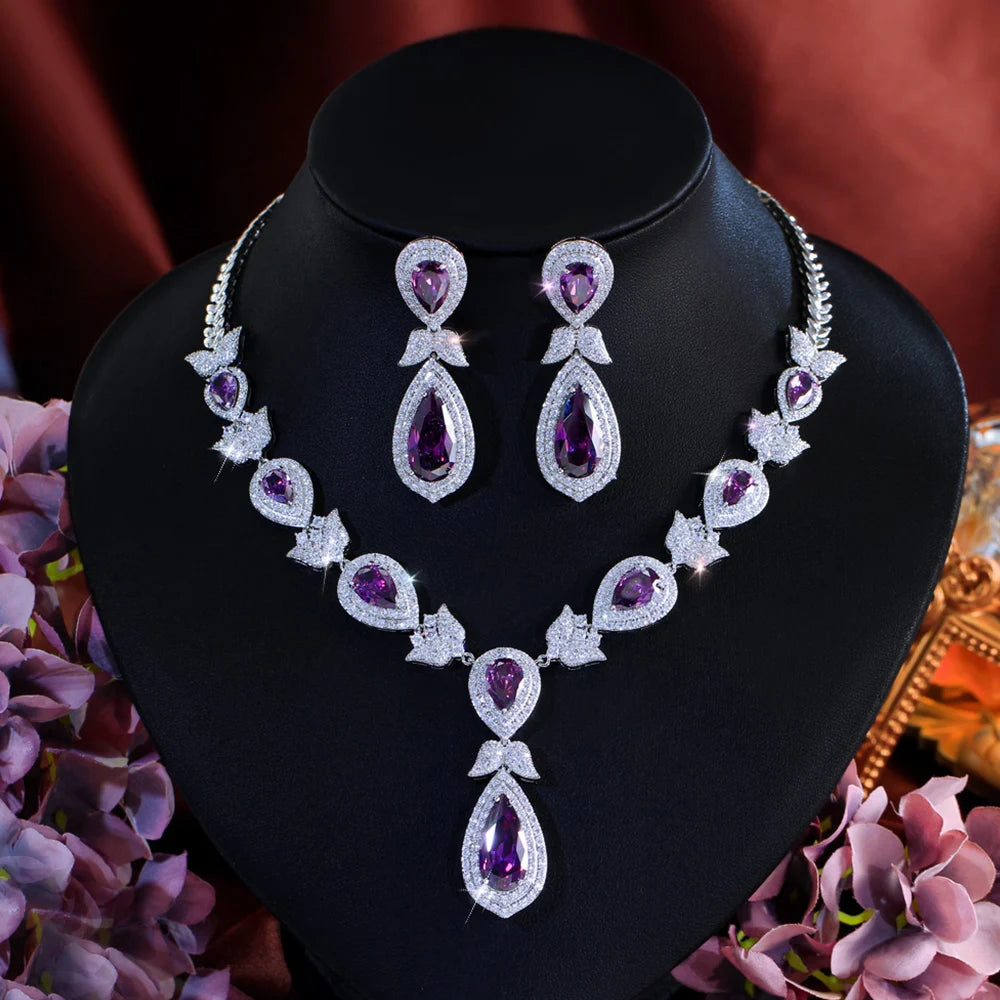 Purple teardrop crystal necklace and matching earrings displayed together