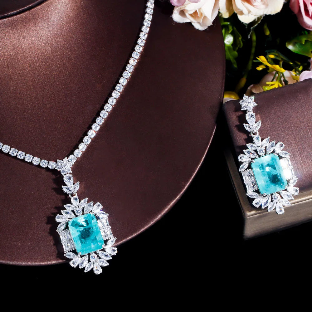 Cubic zirconia necklace and earring set with teal square centerpiece stones, silver-tone