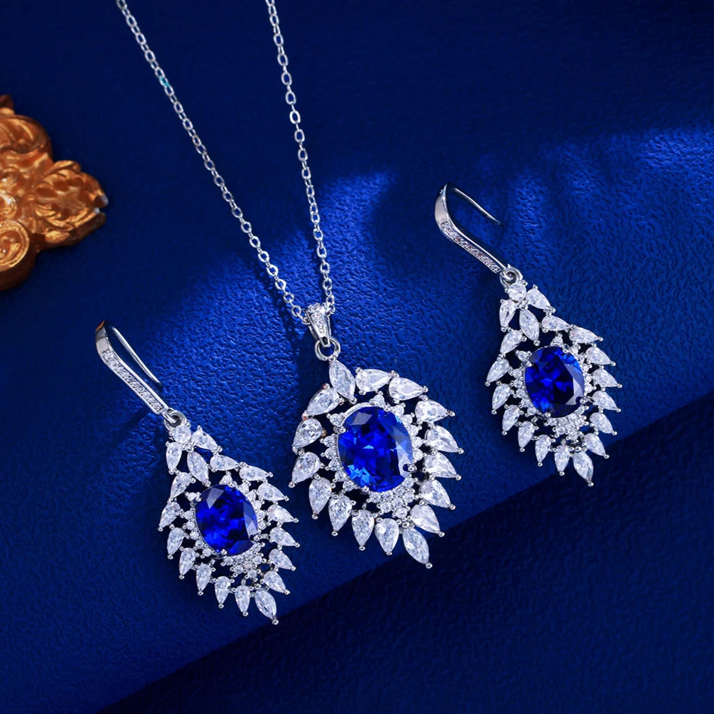 Silver-tone necklace and drop earrings with blue oval stones and clear marquise CZ halos