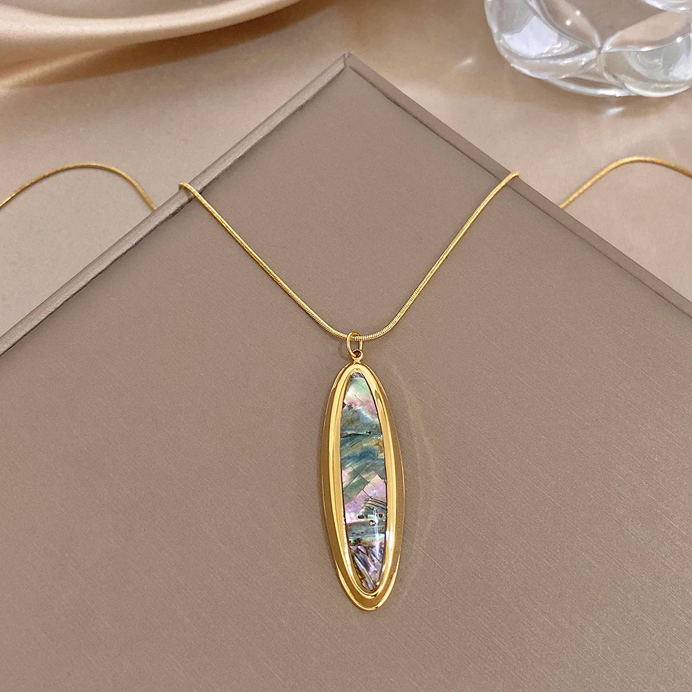 Gold oval abalone shell pendant necklace with thin snake chain, hanging bail