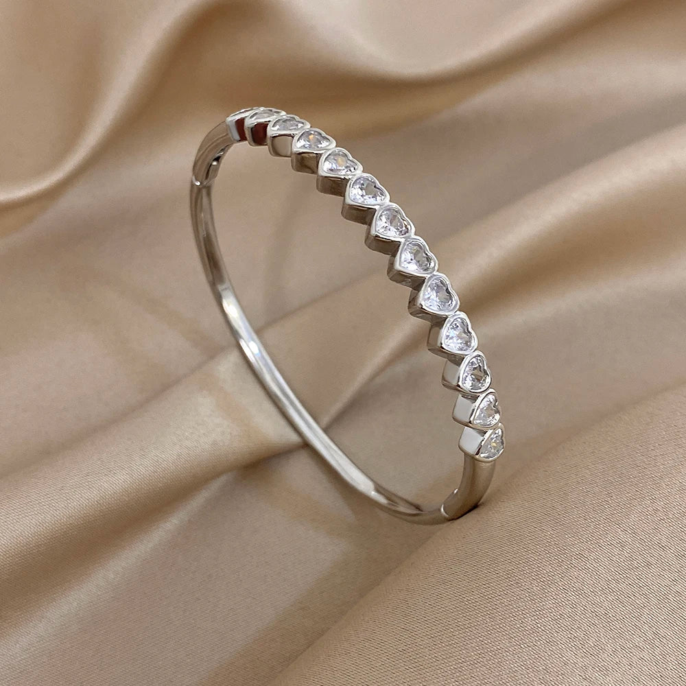 Silver-tone heart crystal inlay cuff bracelet with hinged oval bangle
