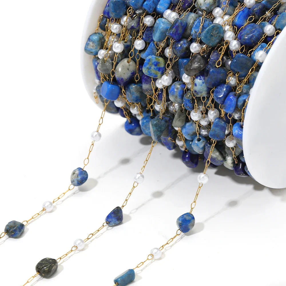Irregular stone bead chain with pearl accents on gold-toned links, blue stone beads