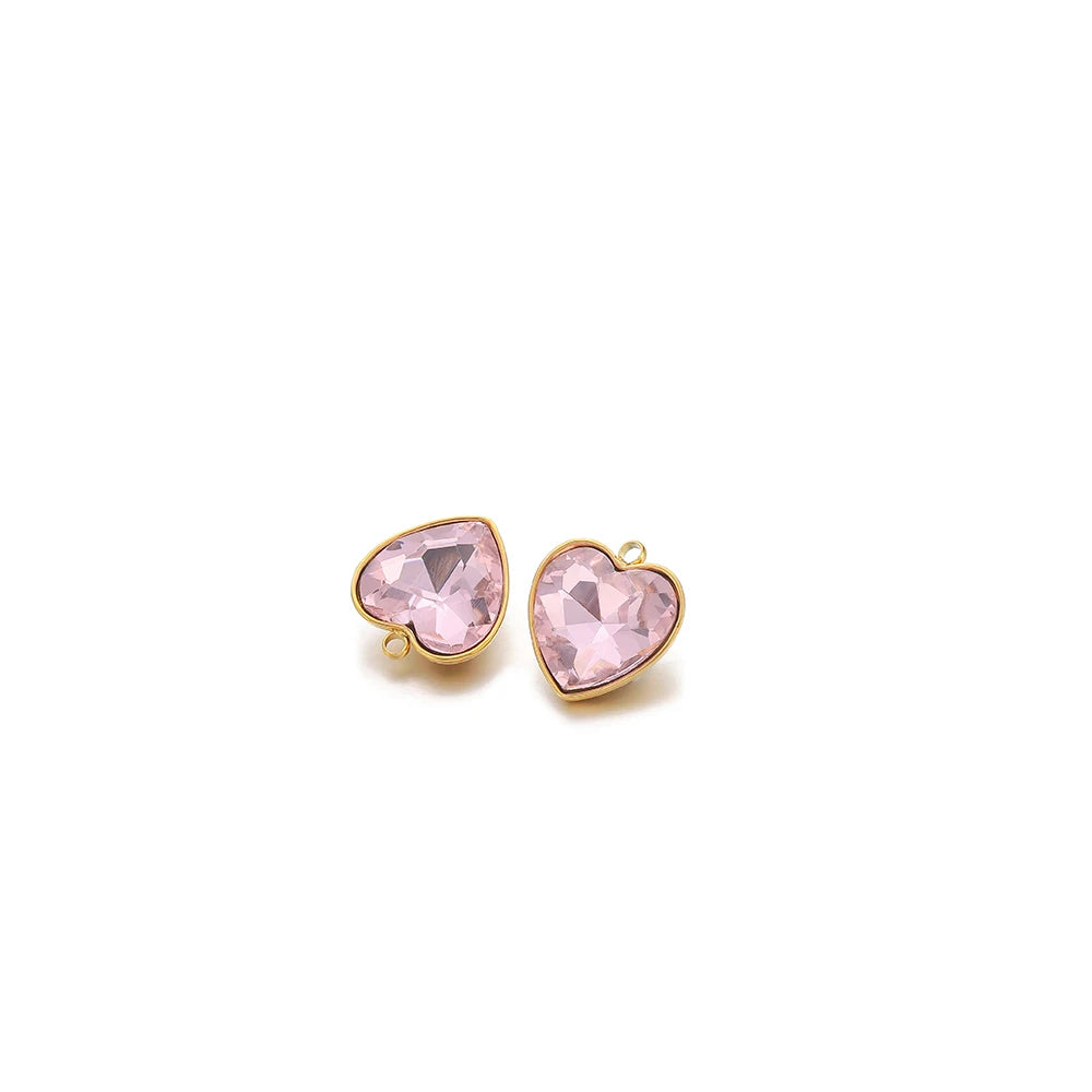 Heart-shaped crystal pendant charm, light pink stone with gold-tone loop bail