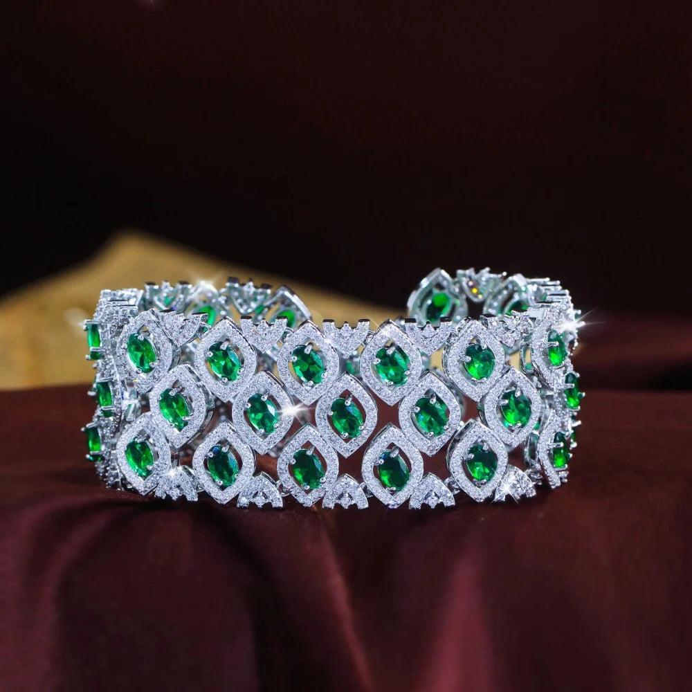 Wide silver-tone bracelet with rows of green marquise-cut stones and clear zirconia