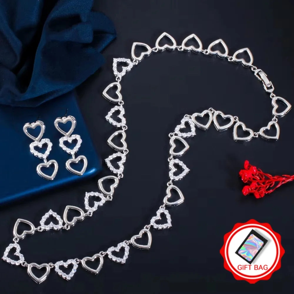 Silver-tone necklace and drop earrings with alternating open and clear jeweled hearts
