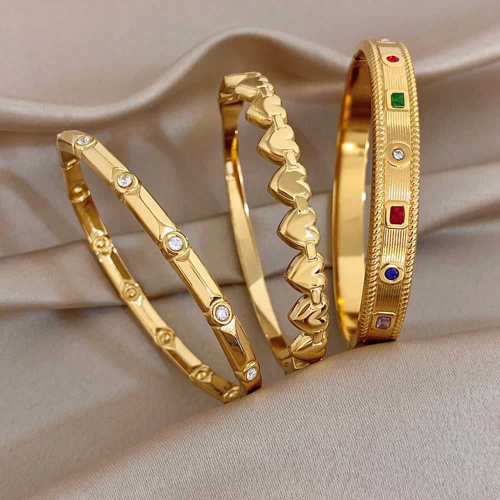 Gold-tone heart-link cuff bangle with multicolor stone insets and rhinestone dots