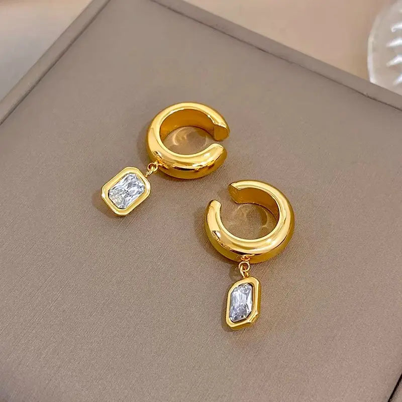 Gold-tone hoop ear clip earrings with dangling square zirconia charms
