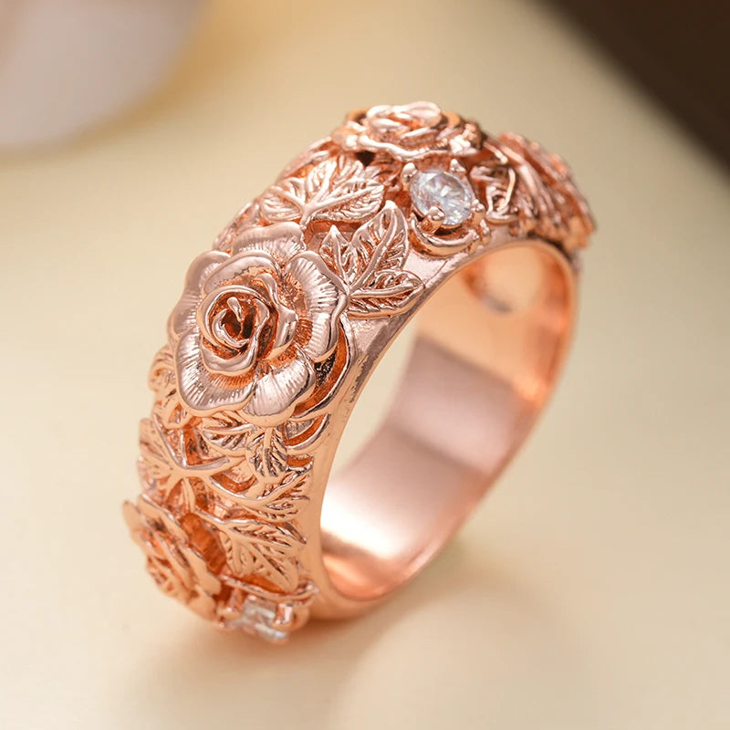 Rose gold floral CZ ring with rose and leaf engravings, sculpted band
