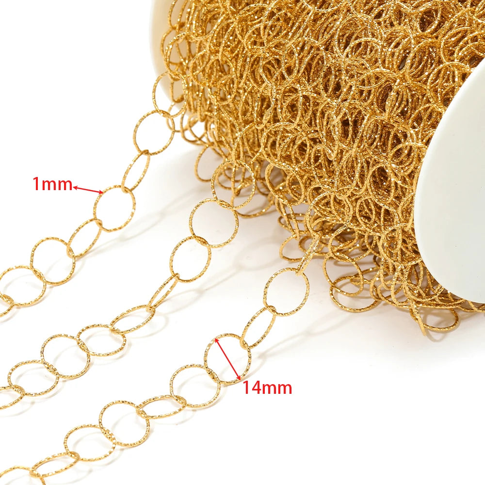Close-up of gold hollow oval chain links with ring texture on spool