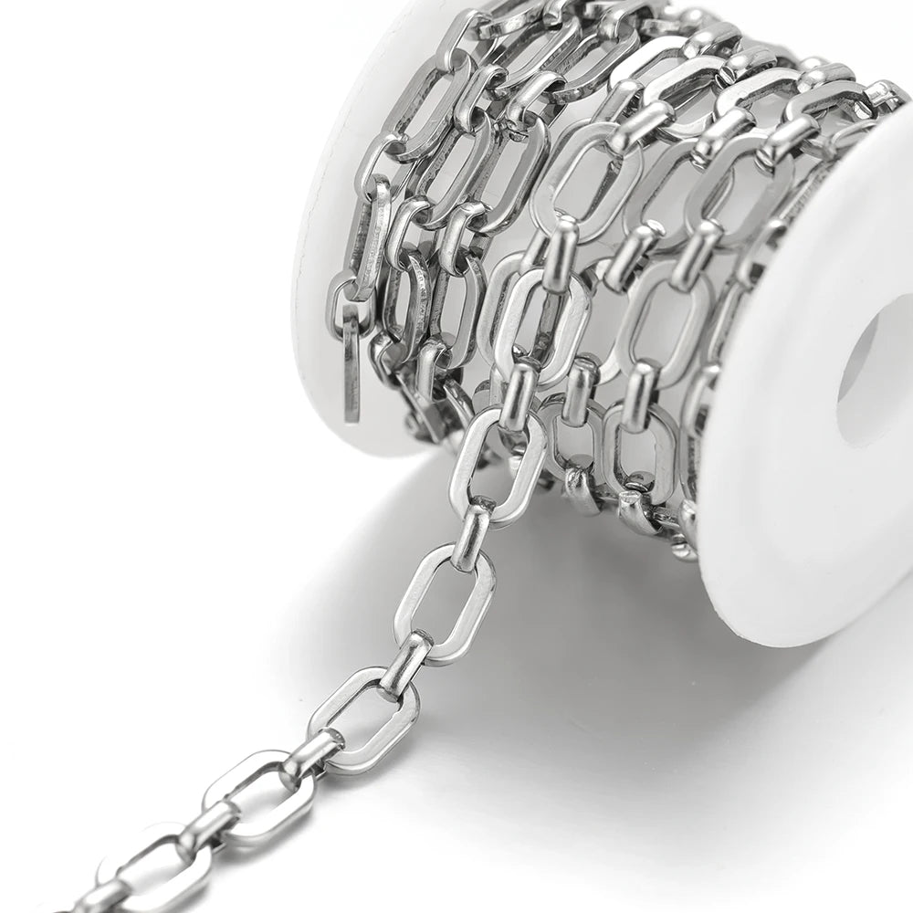 Stainless steel curb chain with long rectangular links and clasp ends on a holder