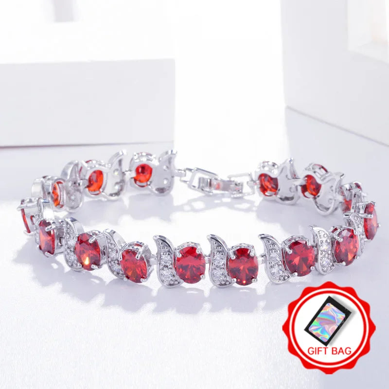 Red oval crystal tennis bracelet with silver-tone leaf accents and clasp
