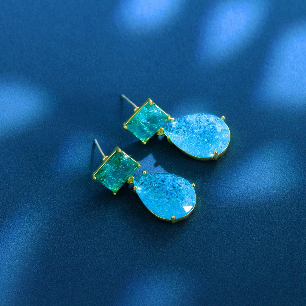 Pair of green square and blue teardrop earrings shown from the back with posts visible