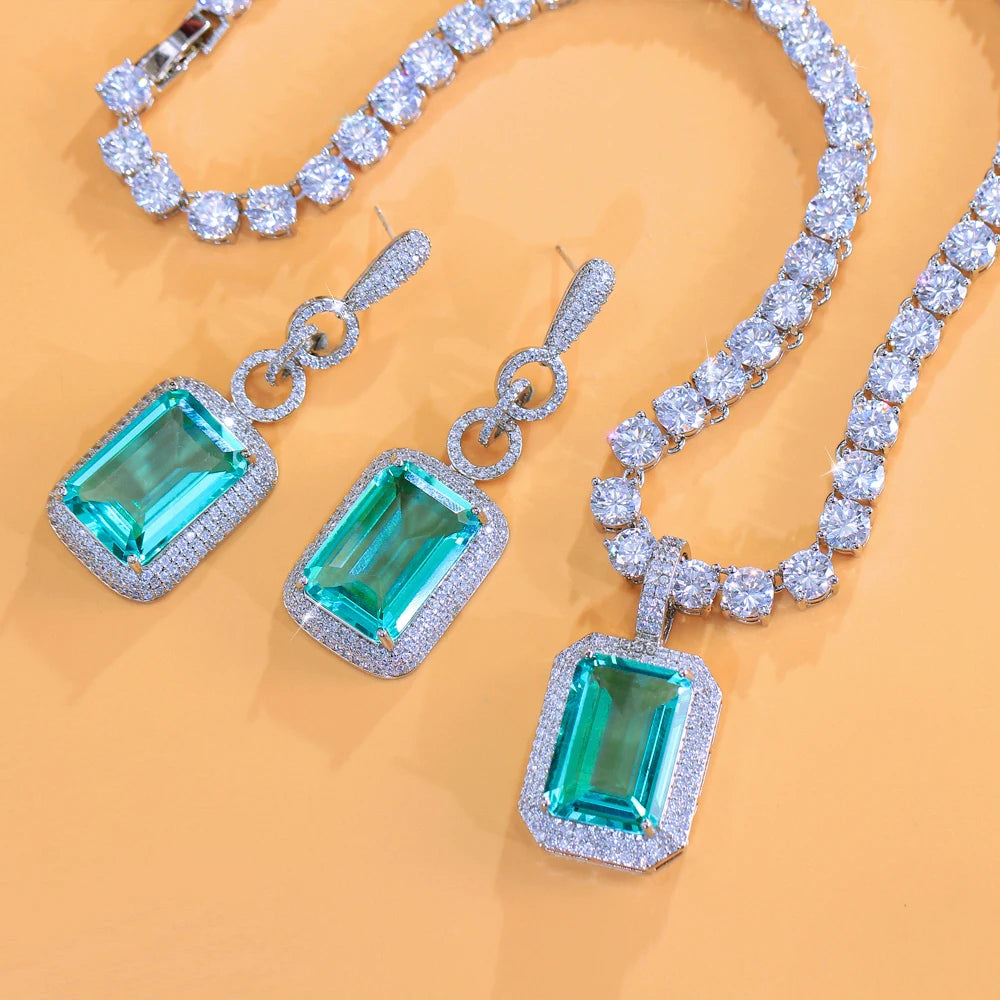 Silver-tone necklace and earrings featuring rectangular teal cubic zirconia stones