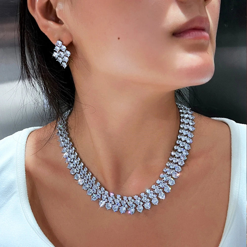 Silver-tone CZ cluster earrings and matching necklace on model, close-up