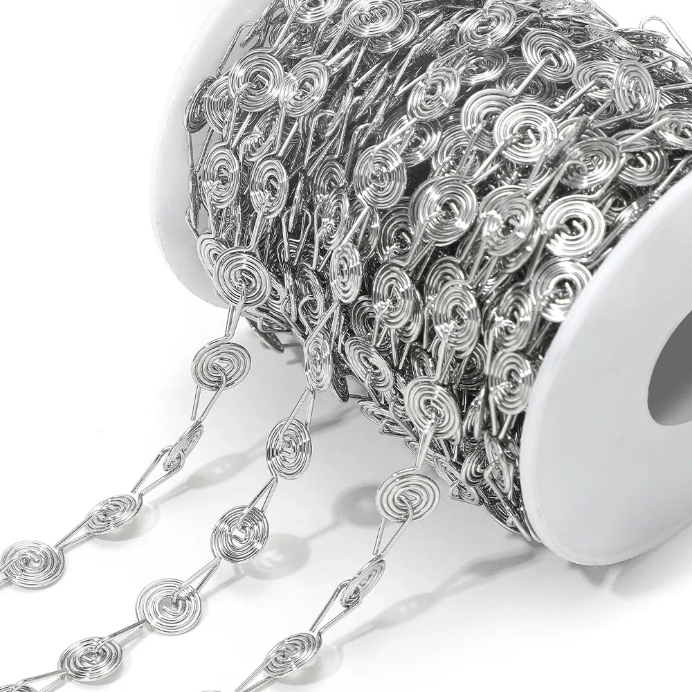 Silver spiral chain roll with repeating flower swirl link loops and drops