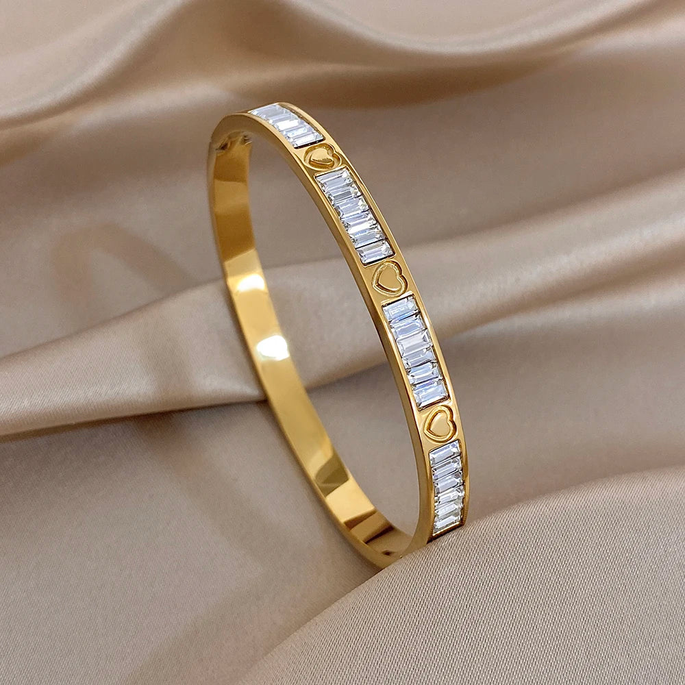 Gold heart zirconia cuff bangle with clear stone band and small heart accents