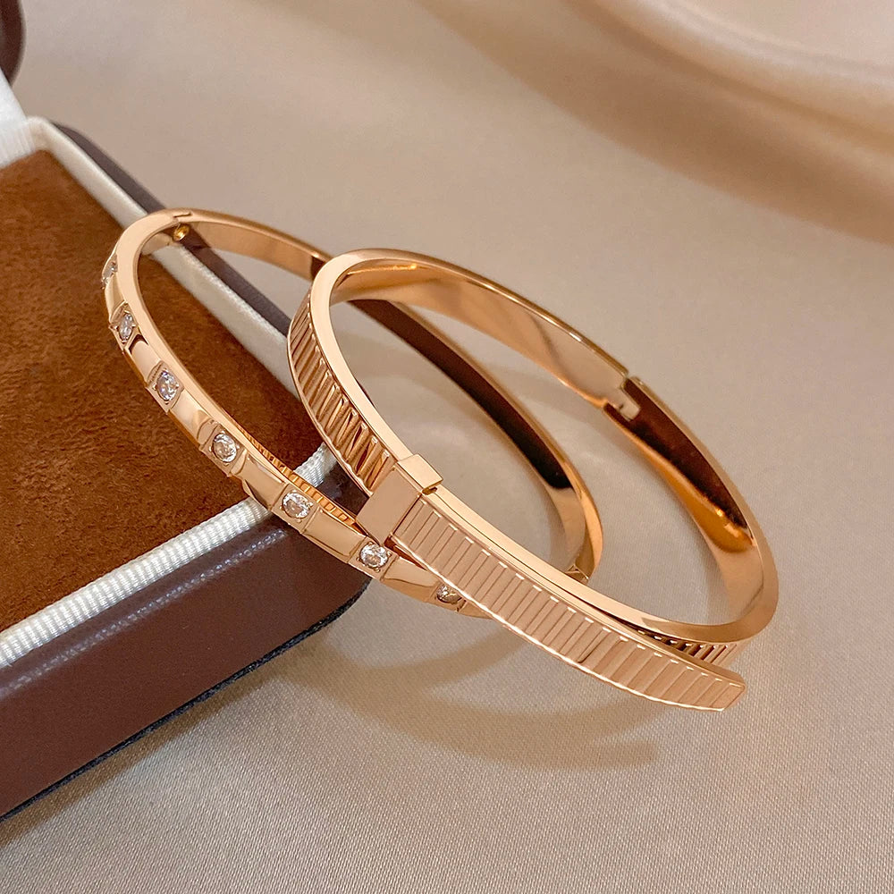 Rose gold cuff bangles with clear stones and ribbed geometric band detail