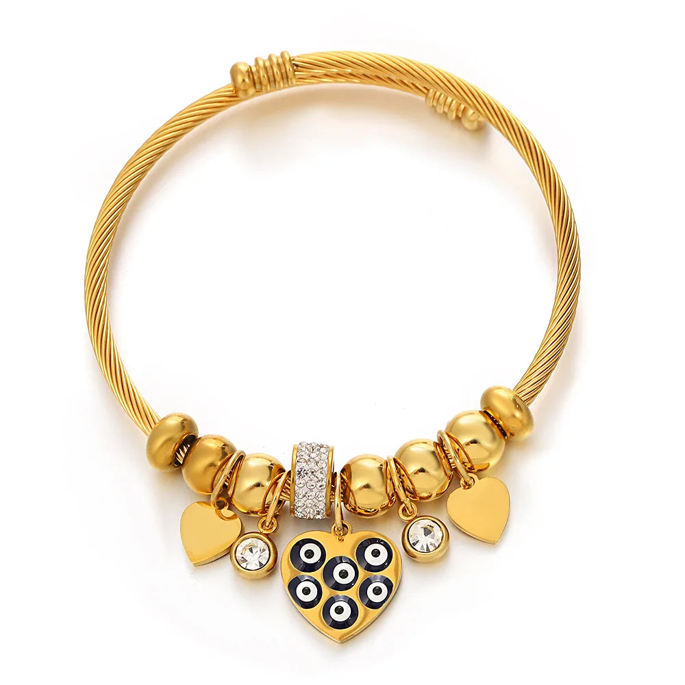 Gold-tone beaded bracelet with heart charms, rhinestone beads, and an owl centerpiece