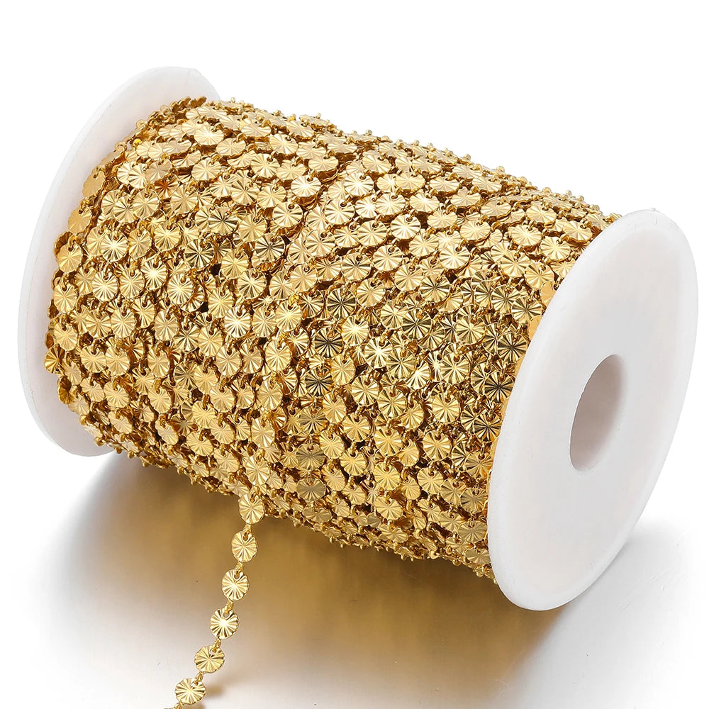 Gold-tone heart-shaped embossed link chain on a white spool