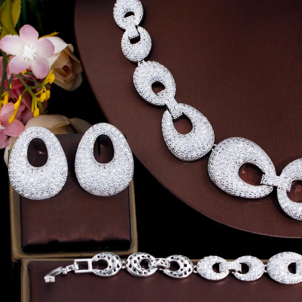 Close-up of silver-tone zirconia oval chain link necklace with matching earrings