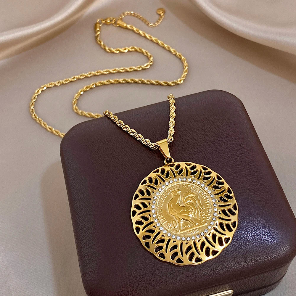 Gold plated waterdrop pendant necklace with ornate coin medallion in lace filigree
