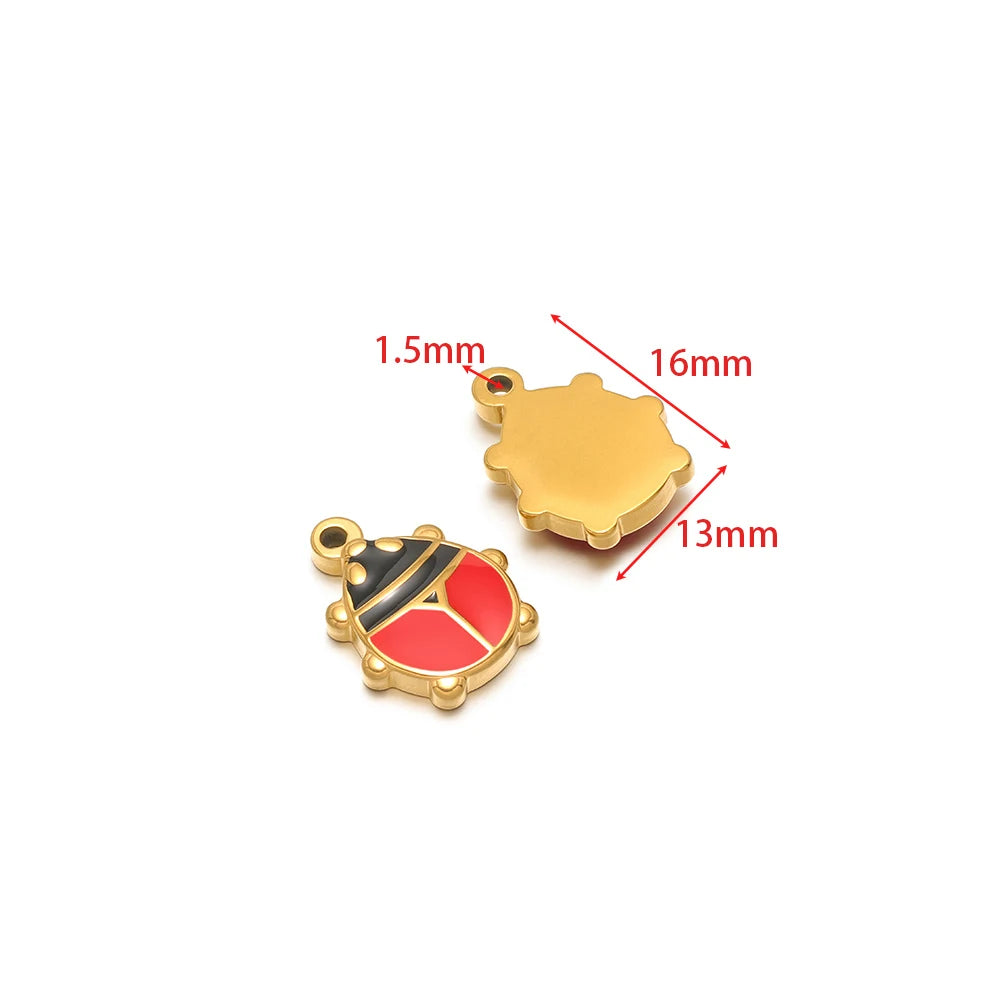 Gold-tone flower-shaped charm pendant; red-and-black enamel charm with loop bail.