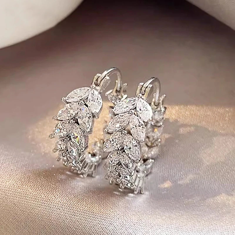 Silver cubic zirconia marquise hoop earrings with clustered stones and round accents