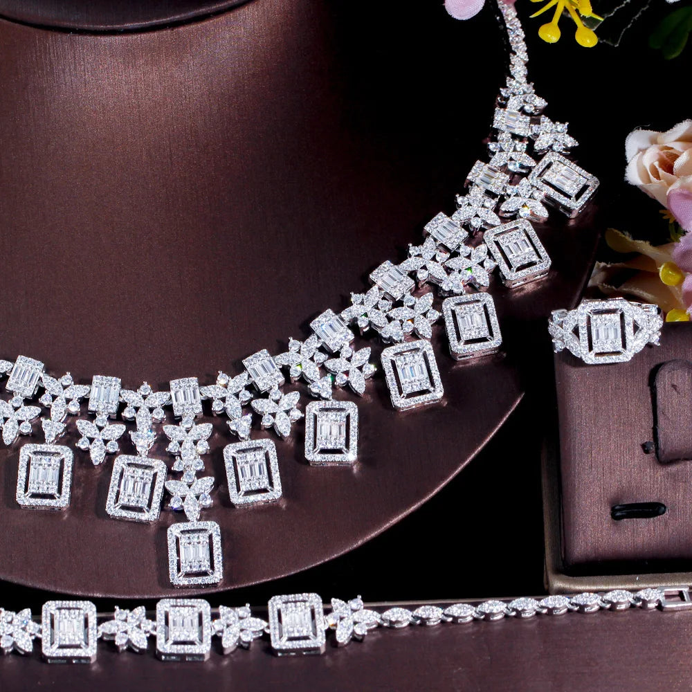 Rhinestone necklace and bracelet with square and star motifs, silver-toned on display