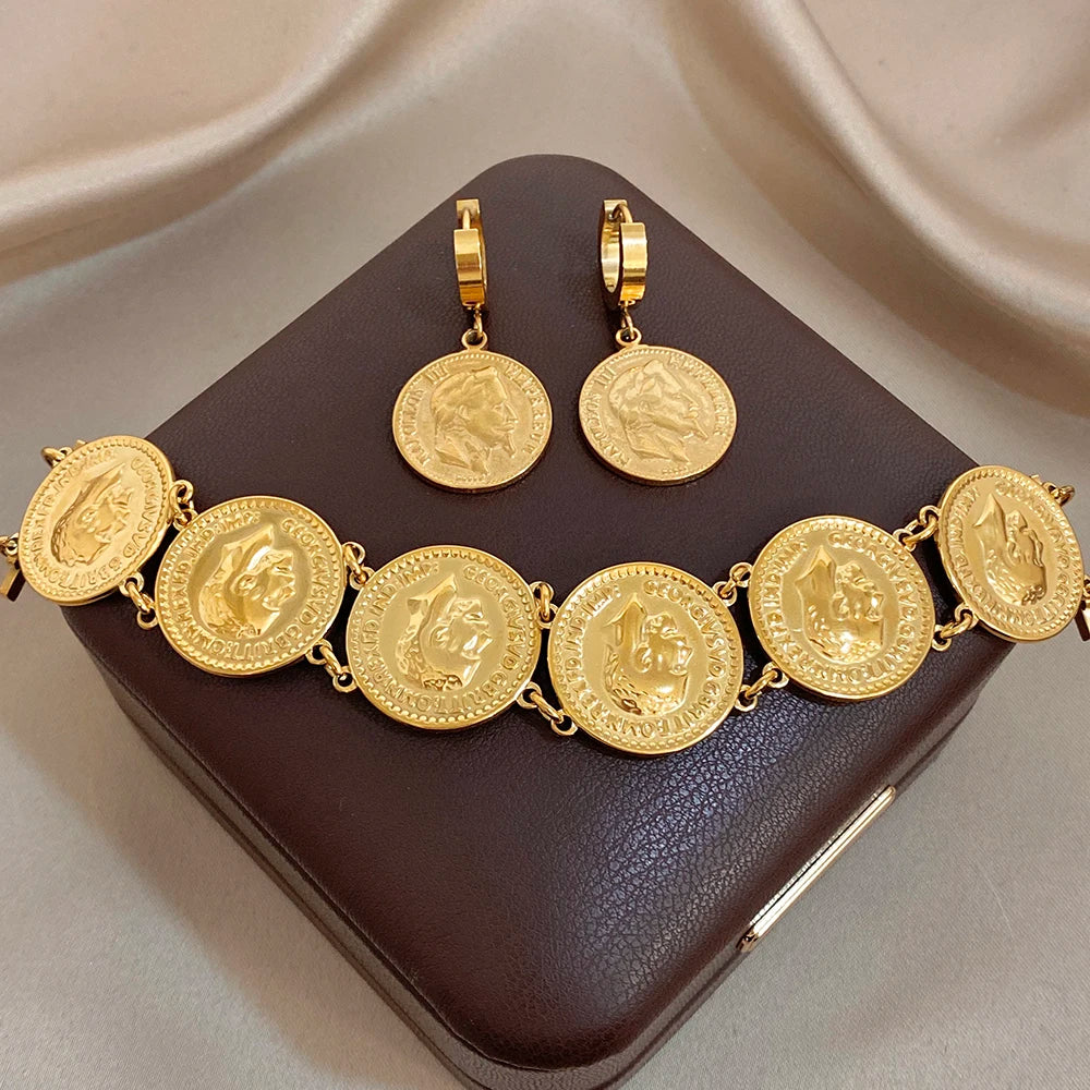 Gold coin charm bracelet with round medallion links