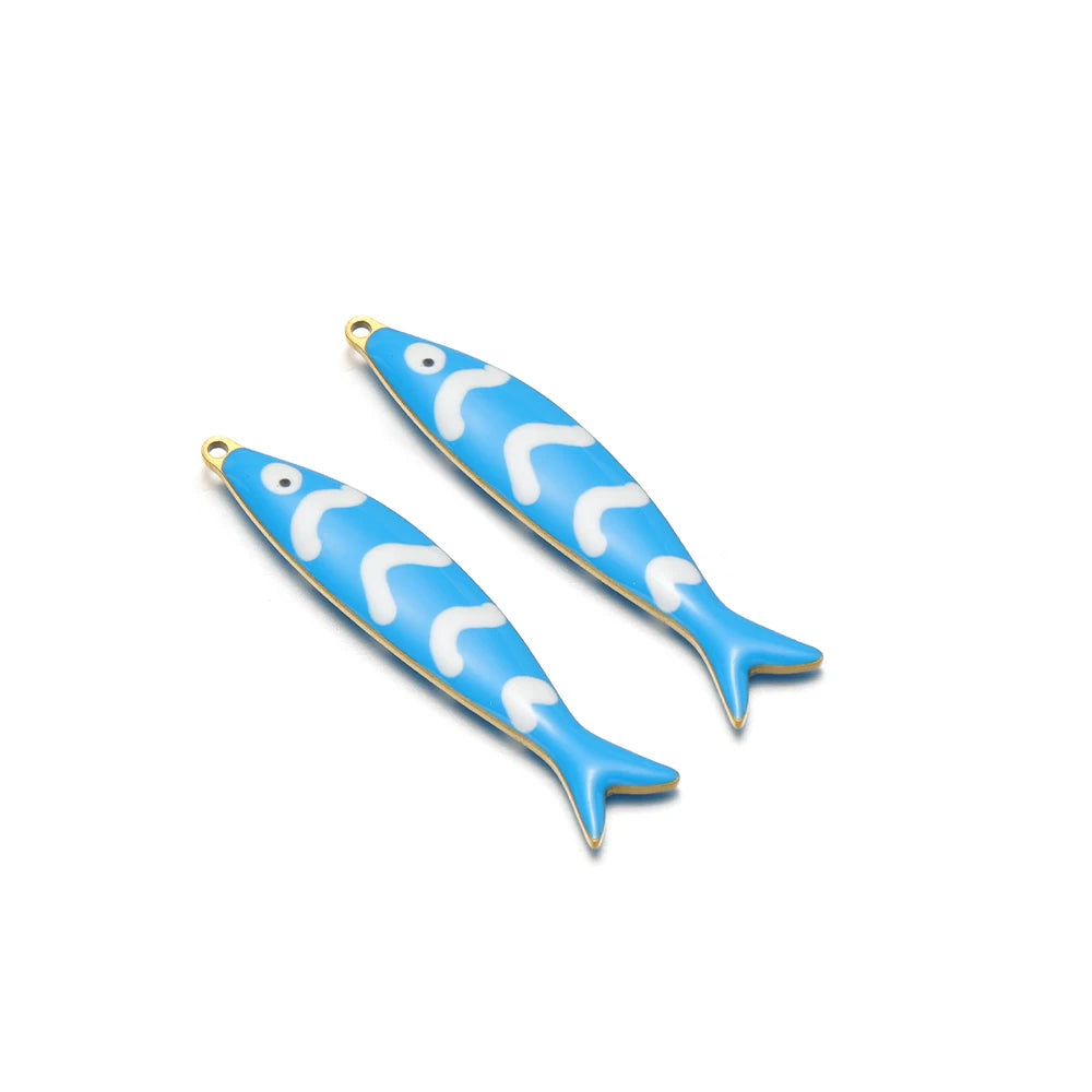 Two blue enamel fish charms with gold-tone loops and white wave patterns