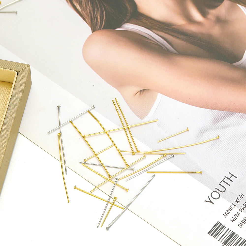Gold and steel T-head flat pins (stainless steel) on a display card