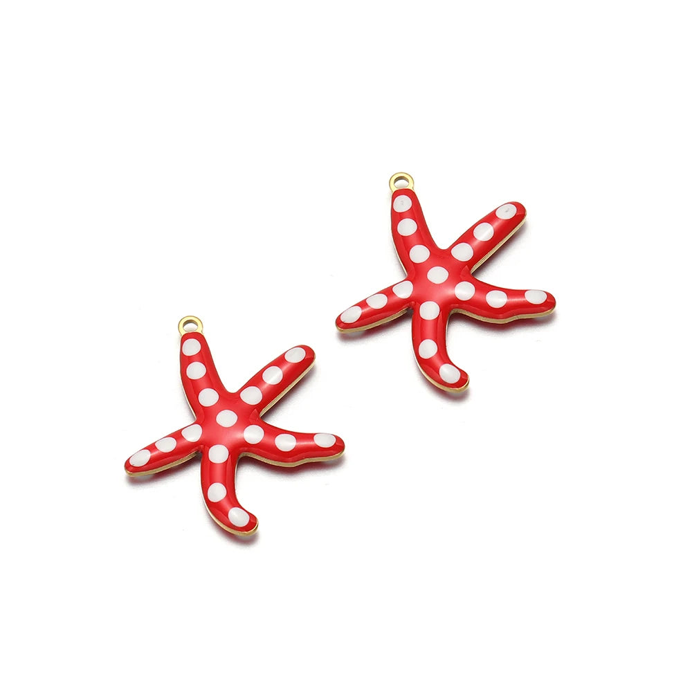 Two red enamel starfish charms with gold-tone loops and white dot accents