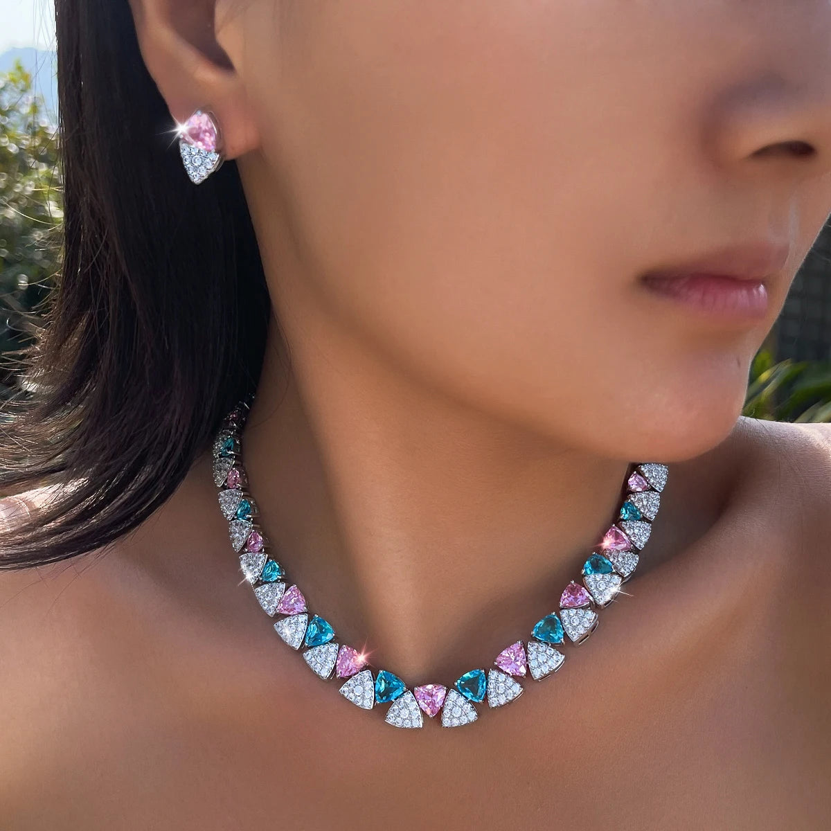Blue, pink, and clear triangle cubic zirconia necklace and earring worn