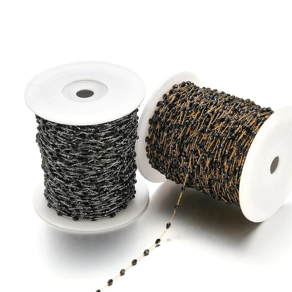 Two spools of black and gold-tone oval crystal bead chain on wire