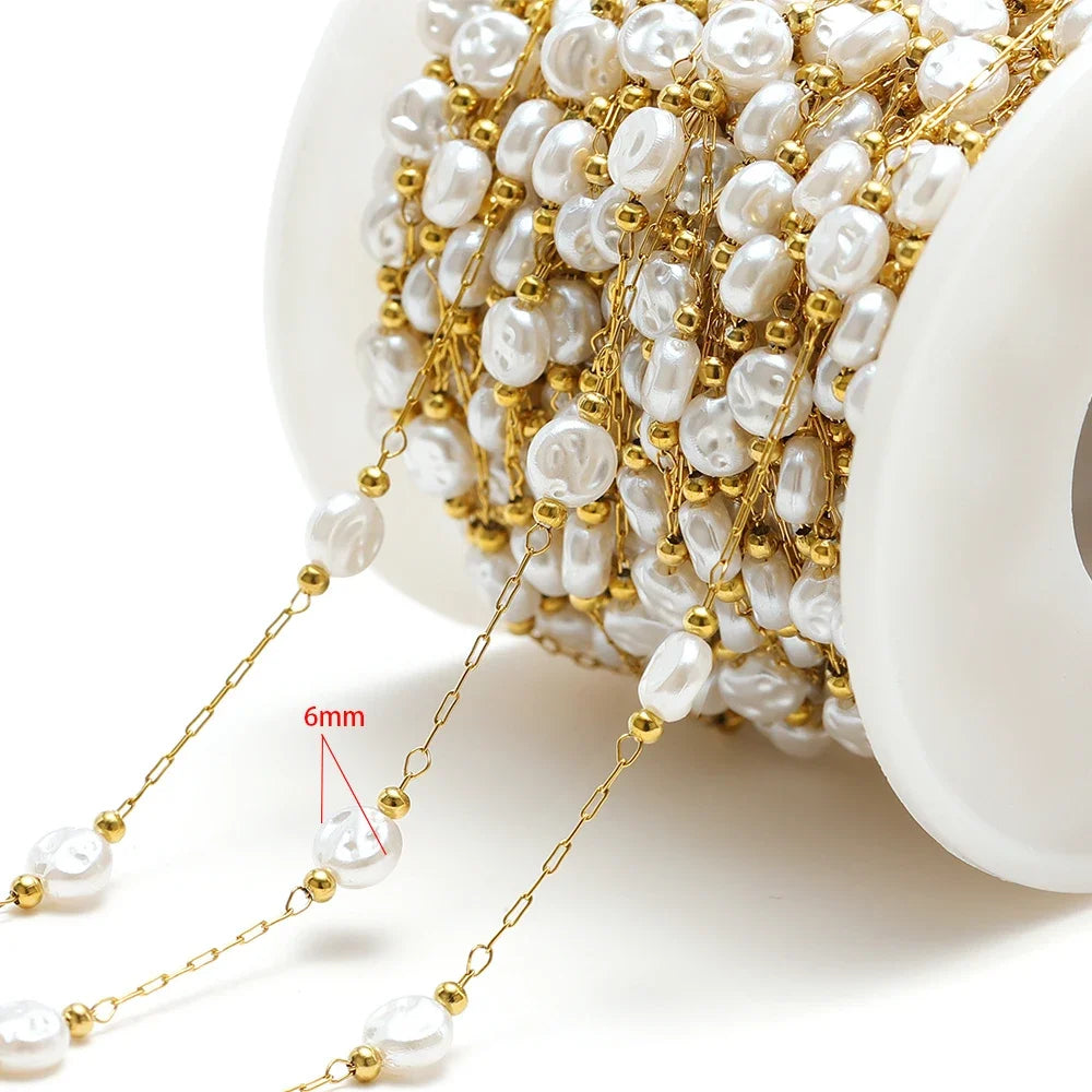 Artificial pearl chain with gold links and 6mm white oval beads