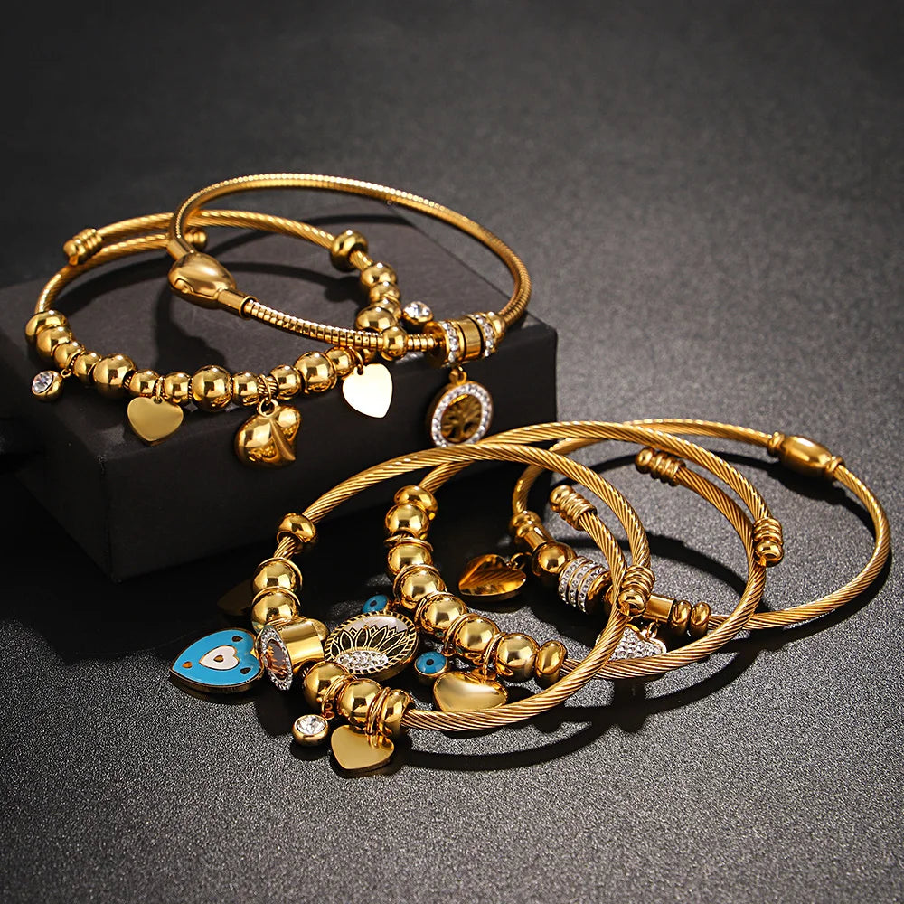 Gold beaded charm bracelets with heart pendants and crystal accents