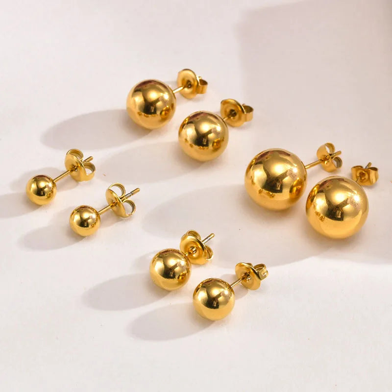 Polished gold-tone ball stud earrings in four sizes, with butterfly backs