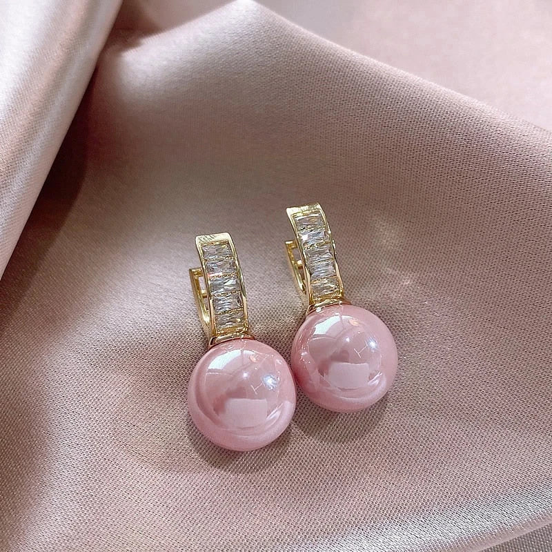 Gold-tone hoop earrings with round pink imitation pearl drops