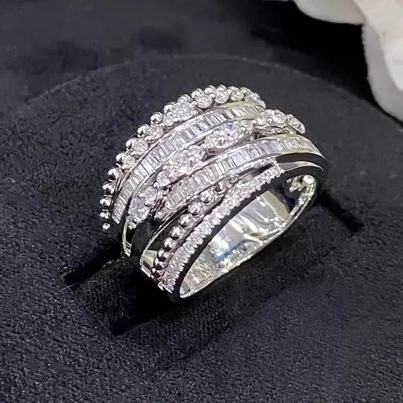 Silver multi-layer cubic zirconia ring with stacked rows of round and baguette-style stones