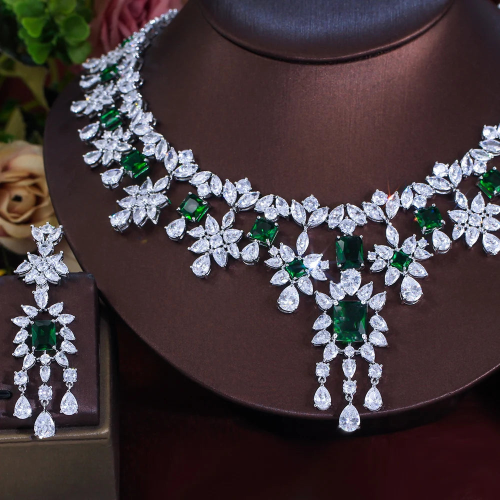 Close-up of floral cubic zirconia necklace and matching green stone drop earrings